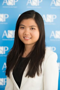 Ngoc Hong Le smiling in front of ASP's photo zone